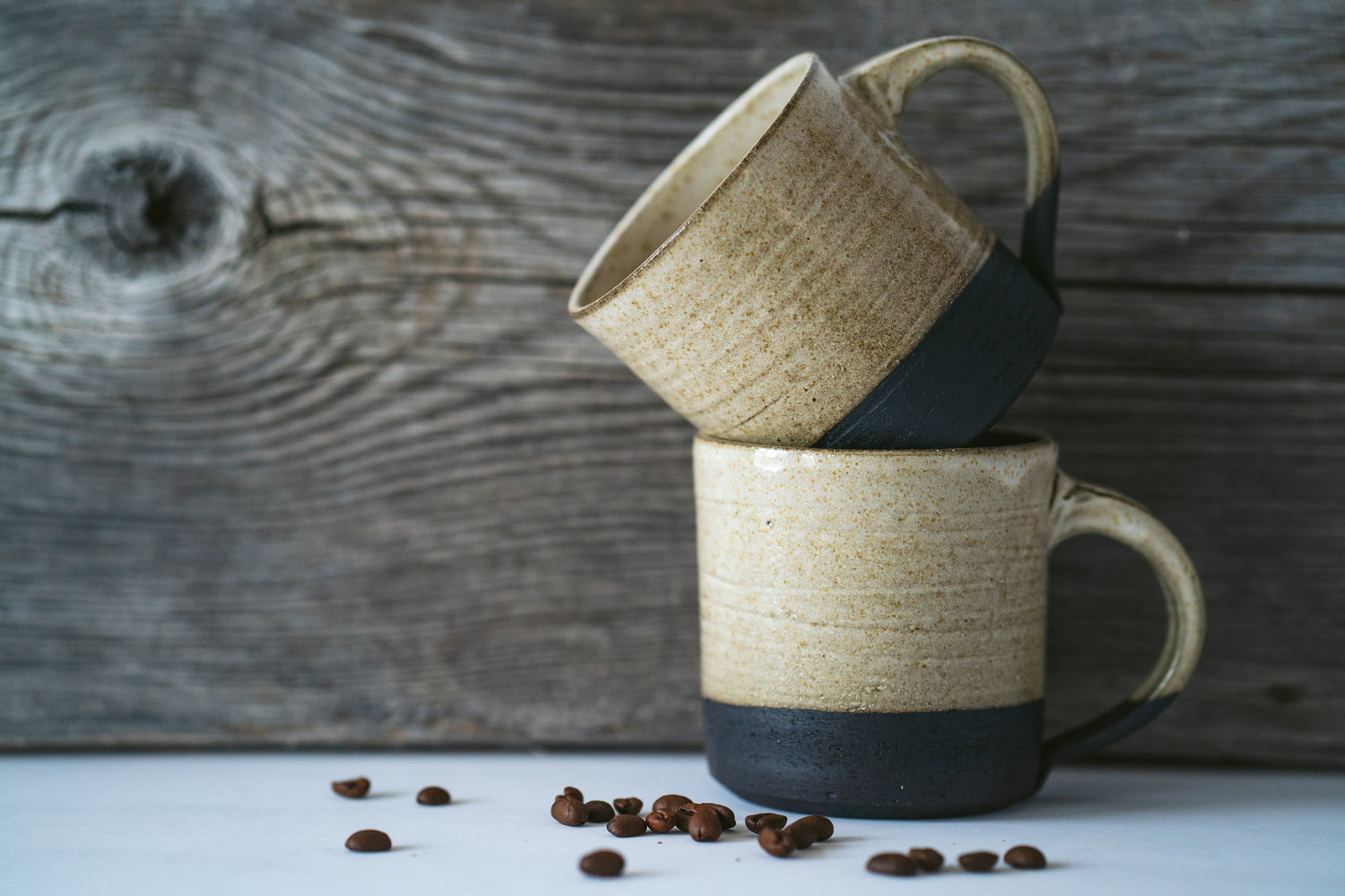 Stack of two short black clay mug