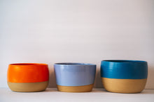 Load image into Gallery viewer, Three different wide table planter in orange, lavender and dark blue
