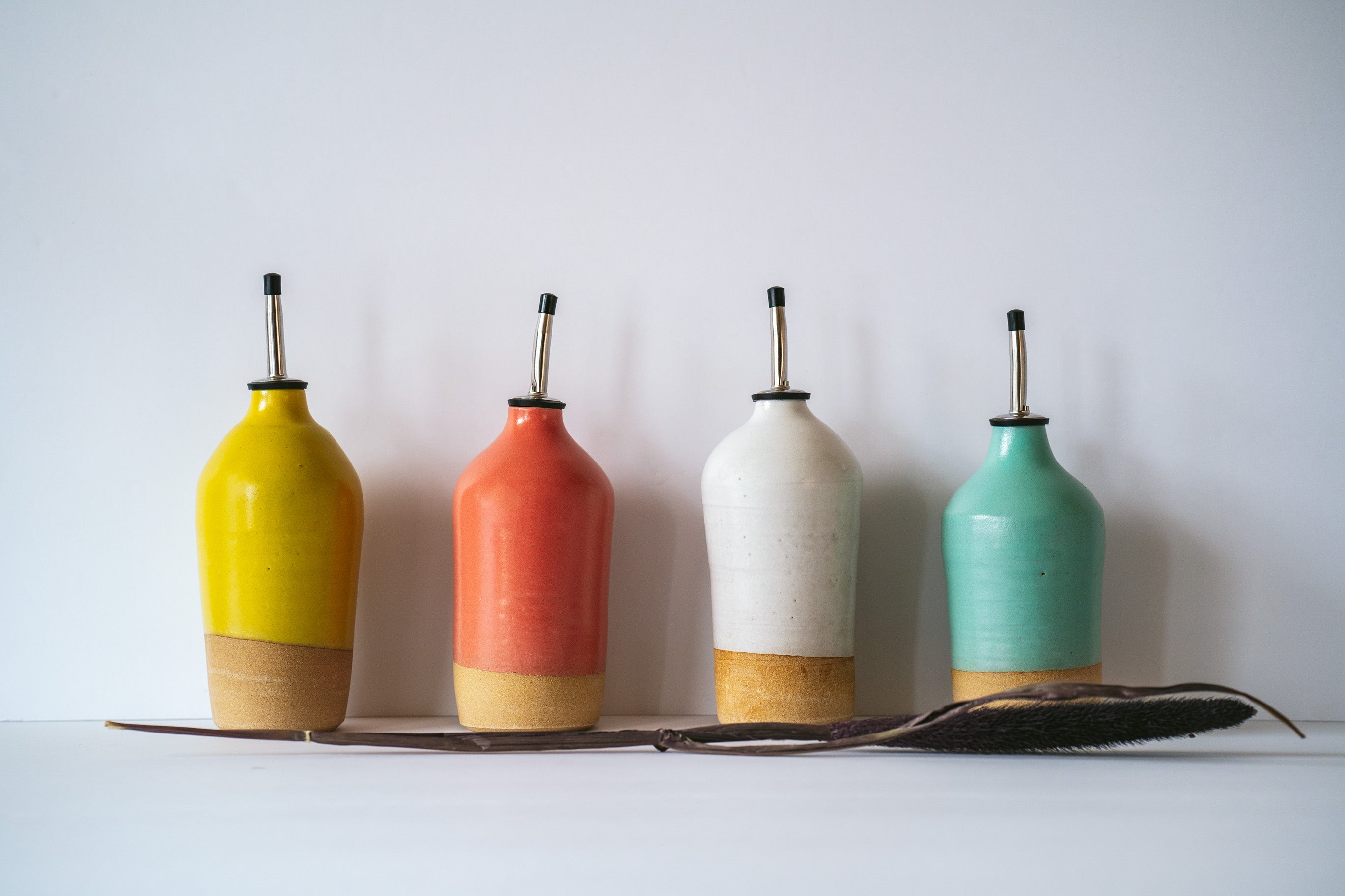 Oil dispenser in Yellow, coral, white and turquoise